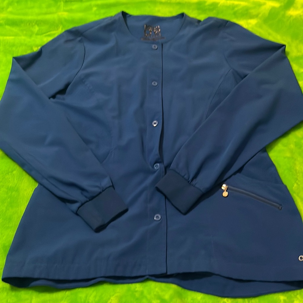 Antimicrobial blue nursing jacket with fitted wrists, button up, well cared for